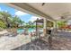 A beautifully landscaped community pool area with plenty of seating, tables, and a covered patio at 5711 Archipelago St, Nokomis, FL 34275