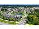 Aerial view of community with pond, fountain, and rows of well-maintained homes at 5905 Silver Sage Way, Sarasota, FL 34232