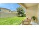 Well-maintained backyard with green grass, privacy fence, and cozy patio set at 5905 Silver Sage Way, Sarasota, FL 34232