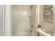 A bathroom features a white tiled shower and modern decor, ensuring a relaxing experience at 5905 Silver Sage Way, Sarasota, FL 34232