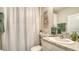 Charming bathroom with elegant decor, decorative paintings, and a stylishly patterned shower curtain at 5905 Silver Sage Way, Sarasota, FL 34232