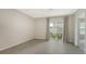 Bright bedroom featuring tile floors and sliding glass doors to the backyard at 5905 Silver Sage Way, Sarasota, FL 34232