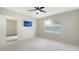 Well-lit bedroom with a ceiling fan, neutral carpet, and mounted television at 5905 Silver Sage Way, Sarasota, FL 34232