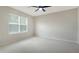 Bright bedroom featuring a ceiling fan and neutral carpet at 5905 Silver Sage Way, Sarasota, FL 34232