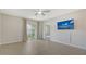 Bright bedroom with tile flooring and sliding door to the patio creates a relaxing and inviting space at 5905 Silver Sage Way, Sarasota, FL 34232