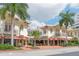 Charming building exterior with architectural details, street-side patios, and lush landscaping at 5905 Silver Sage Way, Sarasota, FL 34232