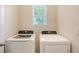 Efficient laundry room featuring modern washer and dryer units, designed for convenience at 5905 Silver Sage Way, Sarasota, FL 34232
