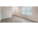 The spacious living room has large windows and tile flooring, providing ample natural light at 5905 Silver Sage Way, Sarasota, FL 34232
