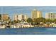 Scenic marina view showcasing luxury yachts, waterfront buildings, and clear blue skies at 5905 Silver Sage Way, Sarasota, FL 34232