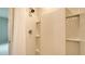 Shower featuring built-in shelving and tiled walls at 5905 Silver Sage Way, Sarasota, FL 34232