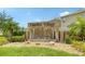 Community entrance featuring a water feature with 'Garden Village' sign and lush landscaping at 5905 Silver Sage Way, Sarasota, FL 34232