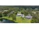 Aerial shot of a home with a pool and lanai, nestled among lush trees and a peaceful lake at 601 136Th St E Ct, Bradenton, FL 34212