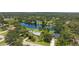 Aerial view of the property showcasing the lake, lush landscaping, and community at 601 136Th St E Ct, Bradenton, FL 34212