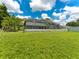 Expansive backyard showcasing the screened-in pool and the house, offering a view of outdoor living at 601 136Th St E Ct, Bradenton, FL 34212