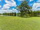 Scenic backyard view with a lake, lush green lawn, and mature trees at 601 136Th St E Ct, Bradenton, FL 34212
