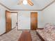 Spacious bedroom features a futon, ceiling fan, and convenient access to other rooms at 601 136Th St E Ct, Bradenton, FL 34212
