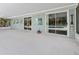 Large covered patio with sliding glass doors leading to the pool area, perfect for outdoor enjoyment at 601 136Th St E Ct, Bradenton, FL 34212