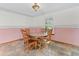 Bright dining area boasts natural light, wooden table, and a decorative light fixture at 601 136Th St E Ct, Bradenton, FL 34212