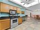 Kitchen with stainless steel oven and microwave, wood cabinets and breakfast bar at 601 136Th St E Ct, Bradenton, FL 34212