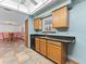 Well-lit kitchen features wood cabinets, a window over the sink and a convenient breakfast bar at 601 136Th St E Ct, Bradenton, FL 34212