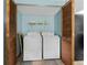 Well-equipped laundry room features front load washer and dryer and storage shelves at 601 136Th St E Ct, Bradenton, FL 34212