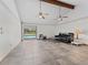 Living room with vaulted ceilings, exposed beam, tile floors, and a sliding glass door view of the pool at 601 136Th St E Ct, Bradenton, FL 34212