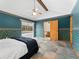 Comfortable bedroom features pool access, ceiling fan, and a convenient ensuite bathroom at 601 136Th St E Ct, Bradenton, FL 34212