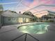 Screened-in pool and jacuzzi, surrounded by a concrete deck and patio with access to the house at 601 136Th St E Ct, Bradenton, FL 34212