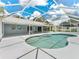 Inviting screened-in pool area featuring a spa and view to the home at 601 136Th St E Ct, Bradenton, FL 34212
