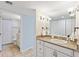 Well-lit bathroom with granite counters, white cabinets, and a shower at 6265 Midnight Pass Rd # 205, Sarasota, FL 34242