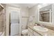 Functional bathroom with stackable washer/dryer, granite vanity, and shower at 6265 Midnight Pass Rd # 205, Sarasota, FL 34242