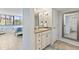 Bright bathroom featuring a vanity with granite countertop and a view of the bedroom at 6265 Midnight Pass Rd # 205, Sarasota, FL 34242