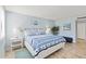 Light and airy bedroom showcasing a queen bed with stylish blue and white bedding at 6265 Midnight Pass Rd # 205, Sarasota, FL 34242