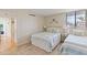 Twin bedroom with matching bedding, a window view, and access to the hallway at 6265 Midnight Pass Rd # 205, Sarasota, FL 34242