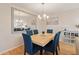 Bright dining room features a modern chandelier, a view of the living room, and seating for six at 6265 Midnight Pass Rd # 205, Sarasota, FL 34242
