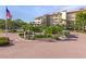 Well-maintained condo entrance with lush landscaping and a decorative fountain at 6265 Midnight Pass Rd # 205, Sarasota, FL 34242