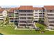 Well-maintained condominium building with garages and lush landscaping at 6265 Midnight Pass Rd # 205, Sarasota, FL 34242