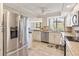 Updated kitchen with stainless steel refrigerator and dishwasher; granite countertops and tiled backsplash at 6265 Midnight Pass Rd # 205, Sarasota, FL 34242