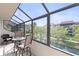 Screened in lanai overlooking a scenic canal and lush landscaping at 6265 Midnight Pass Rd # 205, Sarasota, FL 34242