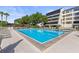 Resort-style pool with ample seating and lush landscaping, adjacent to building at 6265 Midnight Pass Rd # 205, Sarasota, FL 34242