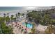 Overhead of the community pool featuring ample seating, tables, and a nearby beach at 6265 Midnight Pass Rd # 205, Sarasota, FL 34242