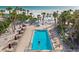 Overhead of resort-style pool and ample seating with white sand beach nearby at 6265 Midnight Pass Rd # 205, Sarasota, FL 34242
