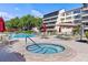 Inviting pool and spa area with tables, chairs, and umbrellas for a relaxing atmosphere at 6265 Midnight Pass Rd # 205, Sarasota, FL 34242