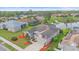 Aerial view of home with lush backyard, complemented by nearby pond at 6266 Buckingham St, Sarasota, FL 34238
