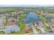 Aerial view of house with pond in the backyard and neighborhood view at 6266 Buckingham St, Sarasota, FL 34238
