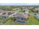 A beautiful home featuring a screened-in pool surrounded by a well-manicured lawn at 6266 Buckingham St, Sarasota, FL 34238