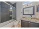 Modern bathroom featuring glass bowl sink, granite countertops, gray tile and shower with glass doors at 6266 Buckingham St, Sarasota, FL 34238