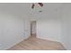 A vacant bedroom with hardwood floor, ceiling fan, and neutral colored walls at 6266 Buckingham St, Sarasota, FL 34238
