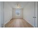 Light and bright bedroom features a window, neutral colored walls, and wood flooring at 6266 Buckingham St, Sarasota, FL 34238