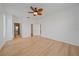 Spacious bedroom with wood floors, ceiling fan, closet and bathroom access at 6266 Buckingham St, Sarasota, FL 34238